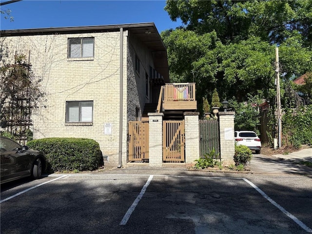 375 6th St NE Unit 5, Atlanta, GA 30308 - view of home's exterior featuring uncovered parking, a gate, and brick siding