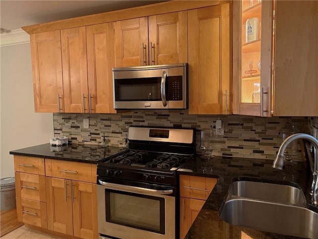 375 6th St NE Unit 5, Atlanta, GA 30308 - kitchen featuring appliances with stainless steel finishes, a sink, dark stone counters, and backsplash