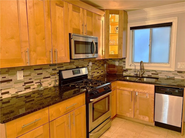 375 6th St NE Unit 5, Atlanta, GA 30308 - kitchen with stainless steel appliances, a sink, dark stone counters, tasteful backsplash, and glass insert cabinets