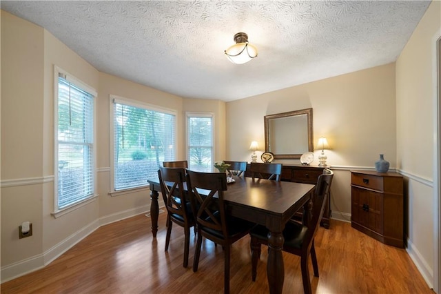 2281 Carlan Rd, Jasper, GA 30139 - dining area featuring light wood-type flooring, a textured ceiling, and baseboards