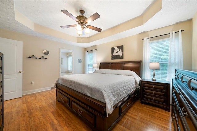 2281 Carlan Rd, Jasper, GA 30139 - bedroom with a raised ceiling, multiple windows, light wood-style flooring, and baseboards
