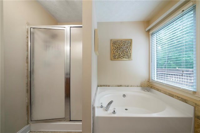 2281 Carlan Rd, Jasper, GA 30139 - full bath with a textured ceiling, a garden tub, and a stall shower