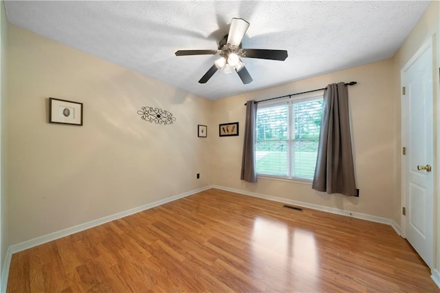 2281 Carlan Rd, Jasper, GA 30139 - empty room with light wood-style flooring, baseboards, a textured ceiling, and a ceiling fan