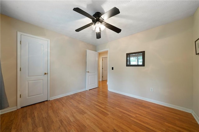 2281 Carlan Rd, Jasper, GA 30139 - unfurnished bedroom featuring light wood-type flooring, baseboards, and a ceiling fan