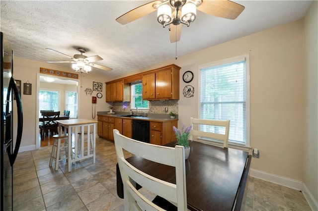 2281 Carlan Rd, Jasper, GA 30139 - kitchen with black appliances, ceiling fan, brown cabinets, and baseboards