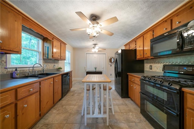 2281 Carlan Rd, Jasper, GA 30139 - kitchen with black appliances, a sink, brown cabinets, and a textured ceiling
