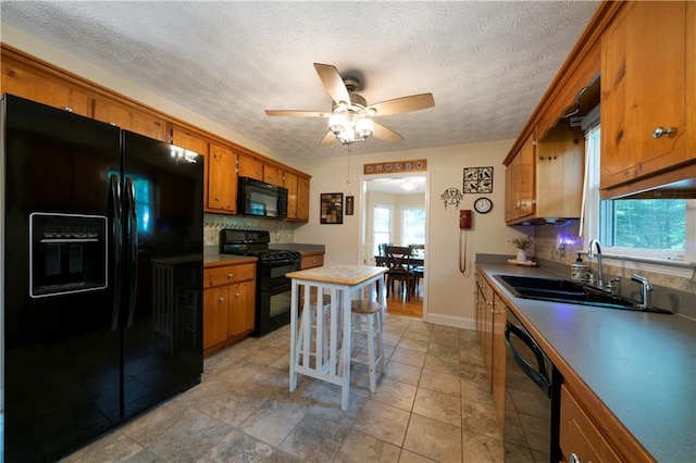 2281 Carlan Rd, Jasper, GA 30139 - kitchen with black appliances, a sink, brown cabinetry, decorative backsplash, and a textured ceiling