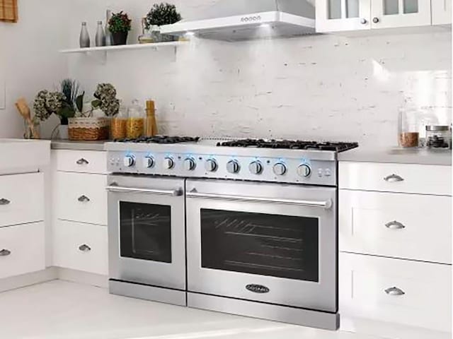 751 Hornage Rd, Ball Ground, GA 30107 - kitchen with range with two ovens, under cabinet range hood, white cabinets, glass insert cabinets, and light countertops