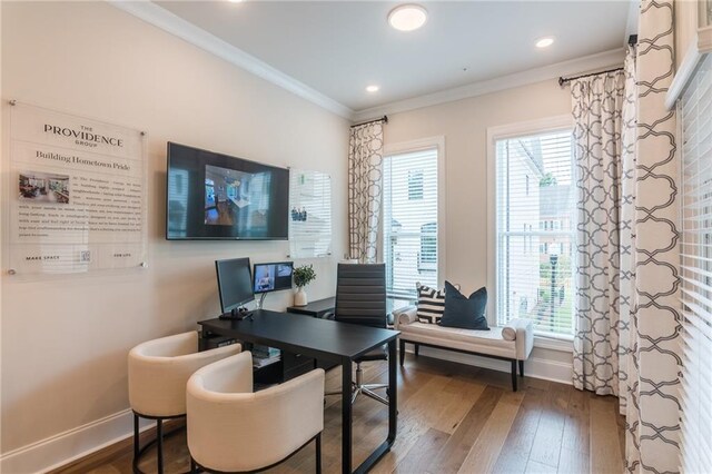 office space featuring dark hardwood / wood-style flooring, ornamental molding, and plenty of natural light