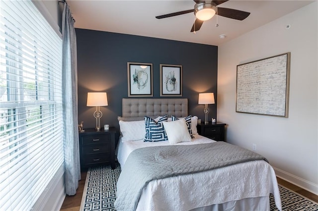 bedroom with dark hardwood / wood-style floors and ceiling fan