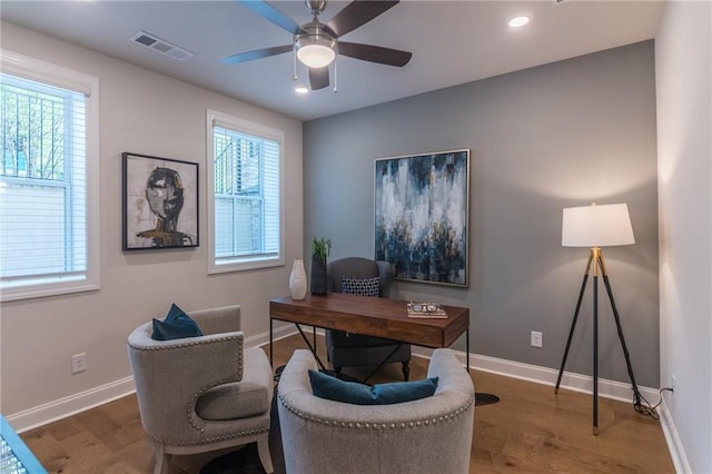 home office with wood-type flooring, a healthy amount of sunlight, and ceiling fan