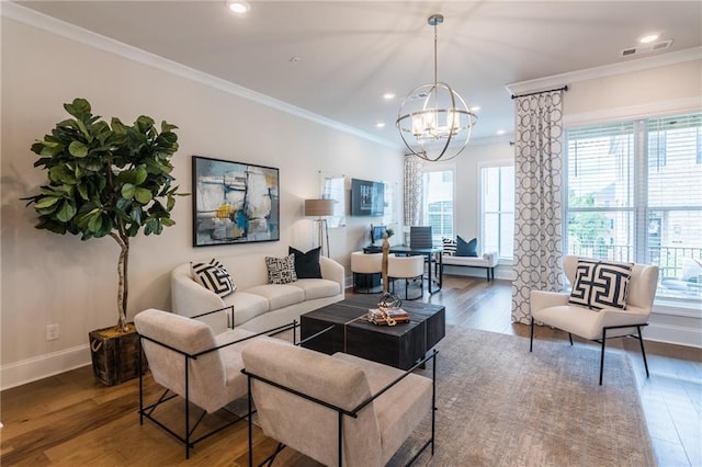 living room with an inviting chandelier, dark wood-type flooring, and ornamental molding