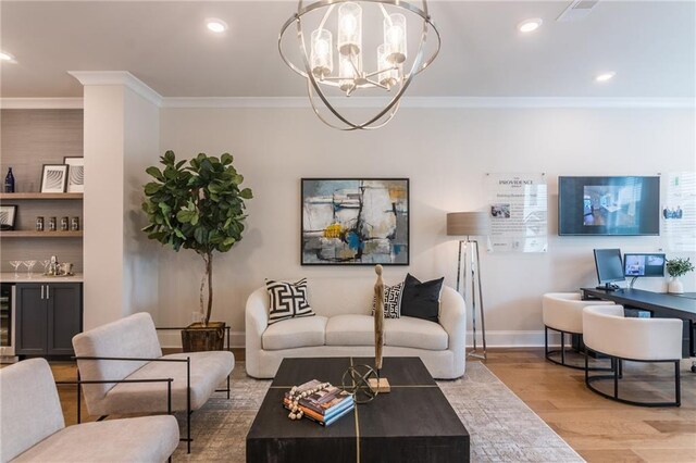 living room featuring light hardwood / wood-style floors, a notable chandelier, and ornamental molding