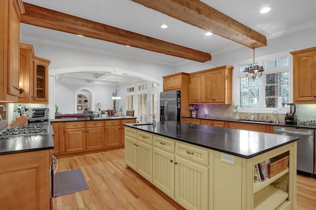 kitchen featuring decorative backsplash, appliances with stainless steel finishes, beamed ceiling, and light hardwood / wood-style floors