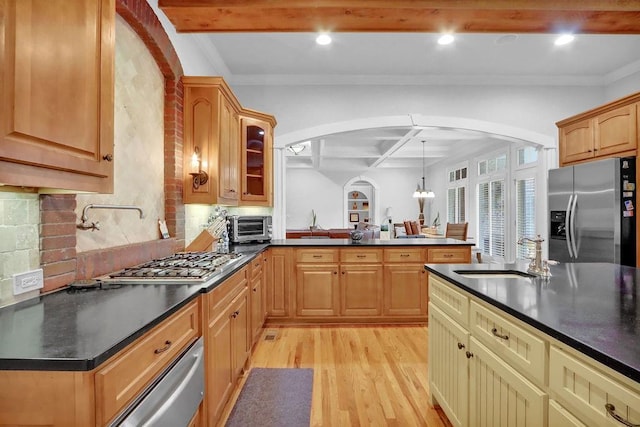 kitchen with beam ceiling, crown molding, light hardwood / wood-style flooring, stainless steel appliances, and sink