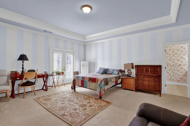 carpeted bedroom featuring a raised ceiling