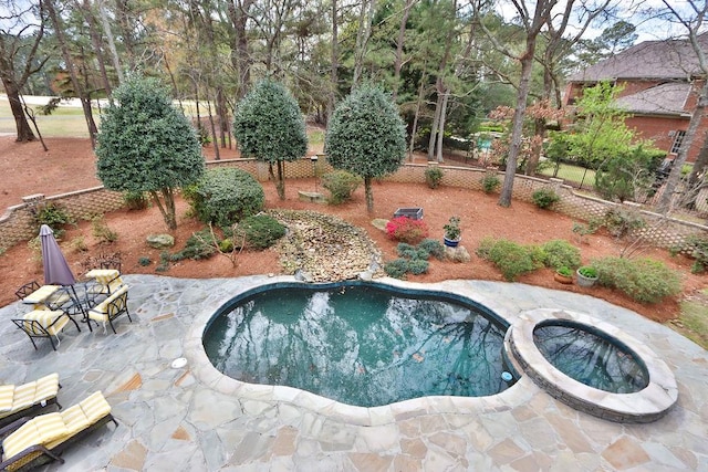 view of pool with an in ground hot tub and a patio