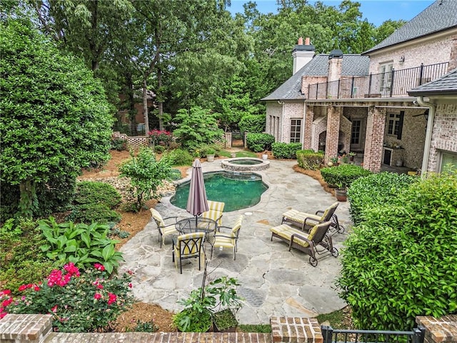 view of pool featuring an in ground hot tub and a patio