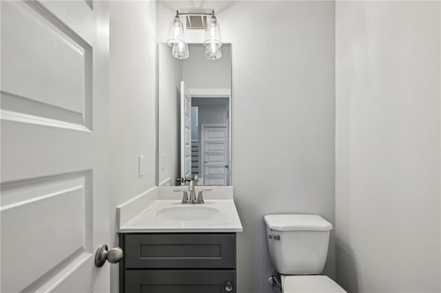 bathroom featuring toilet and vanity