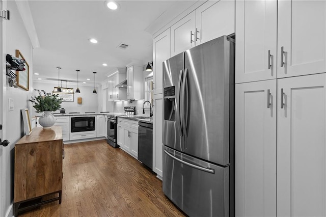 kitchen featuring recessed lighting, dark wood-style floors, white cabinets, black appliances, and a sink