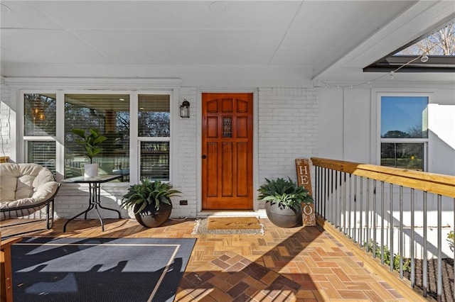 view of exterior entry featuring covered porch