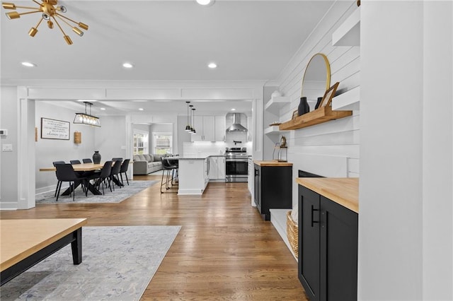 living area featuring light wood finished floors, recessed lighting, baseboards, and an inviting chandelier