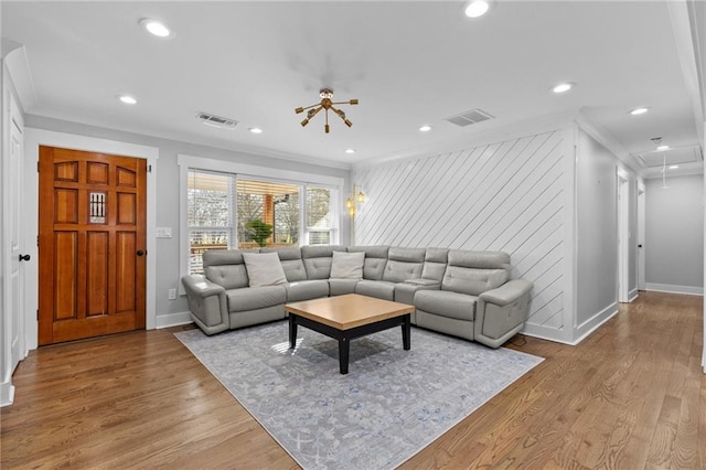 living room featuring visible vents, attic access, and crown molding