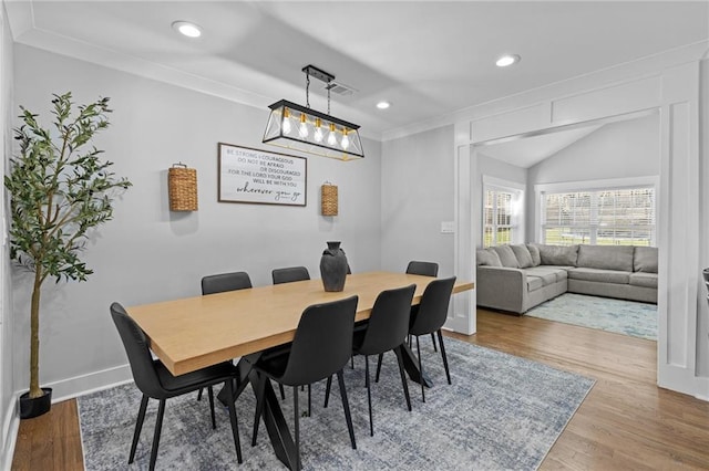 dining space with recessed lighting, wood finished floors, baseboards, and ornamental molding