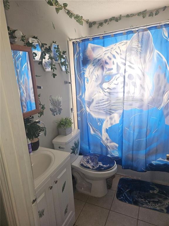 full bathroom with toilet, a shower with curtain, vanity, and tile patterned floors