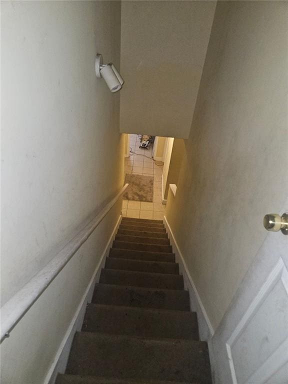 staircase featuring tile patterned floors