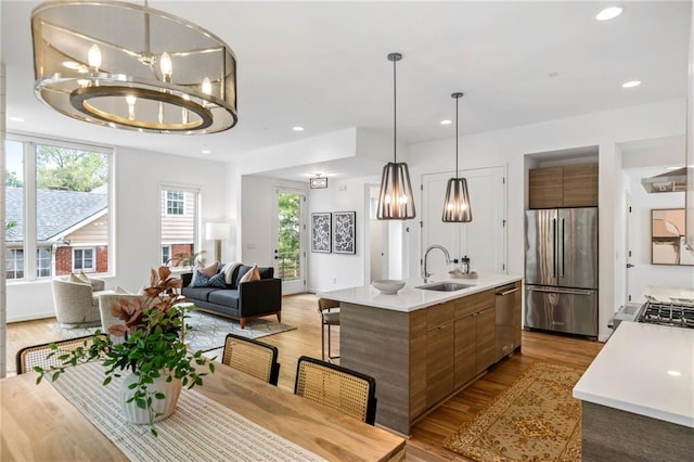 dining space featuring recessed lighting, light wood-type flooring, and a notable chandelier