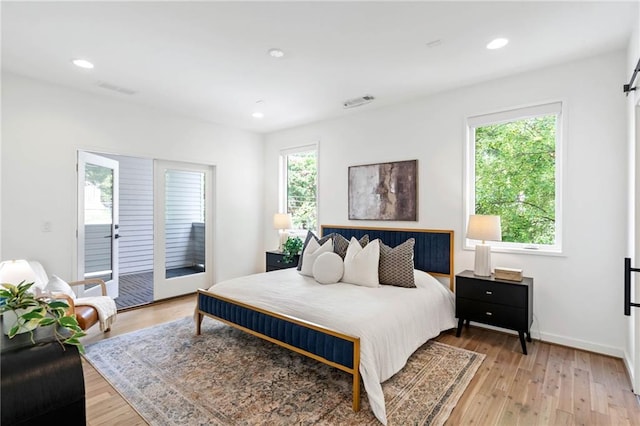 bedroom featuring visible vents, access to exterior, light wood-style floors, baseboards, and recessed lighting