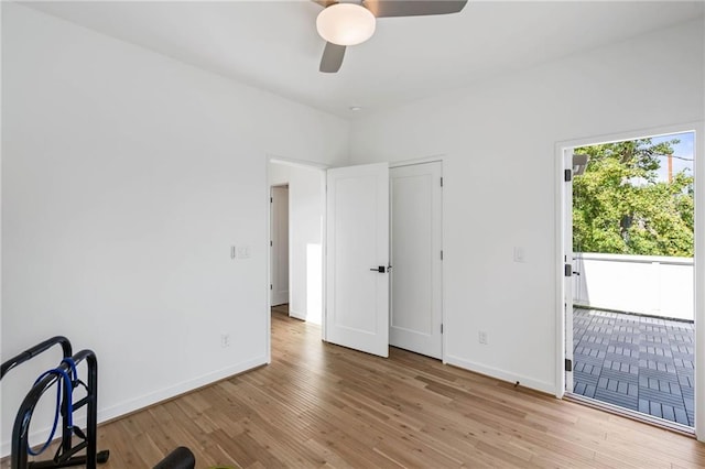 empty room with baseboards, ceiling fan, and wood finished floors