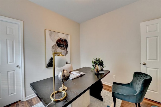 office space with baseboards and wood finished floors