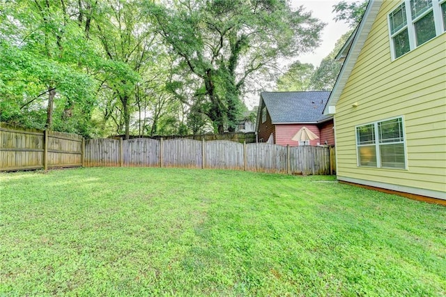 view of yard with a fenced backyard