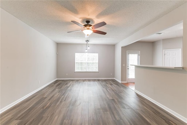 empty room featuring ceiling fan, hardwood / wood-style flooring, and a textured ceiling