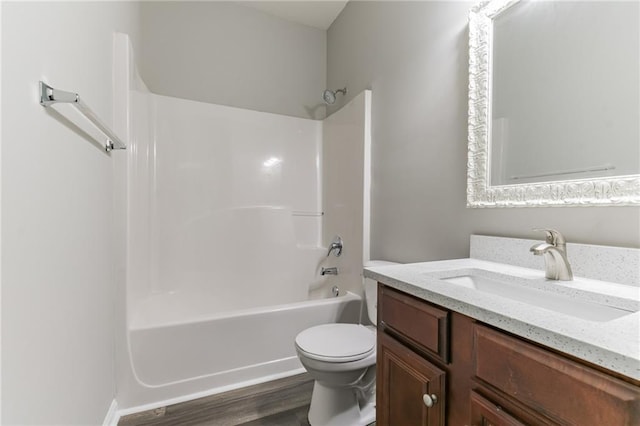 full bathroom with toilet, hardwood / wood-style floors, shower / bathtub combination, and vanity