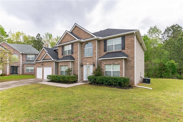 view of front of property with a garage, central AC unit, and a front lawn