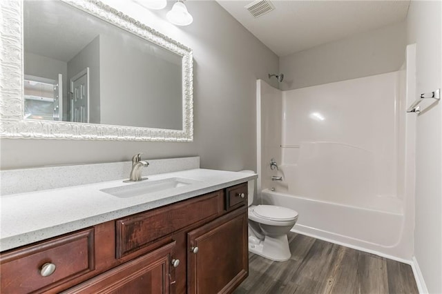 full bathroom featuring shower / bath combination, wood-type flooring, toilet, and vanity