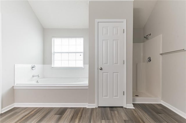 bathroom featuring wood-type flooring and separate shower and tub