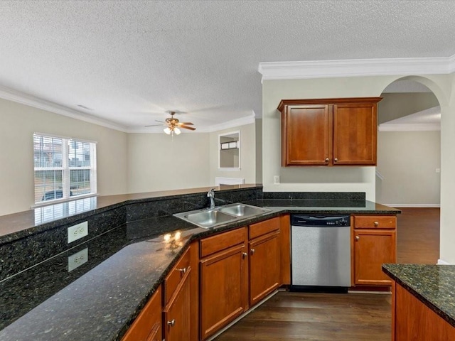 kitchen with sink, dark stone countertops, dark hardwood / wood-style flooring, ornamental molding, and stainless steel dishwasher