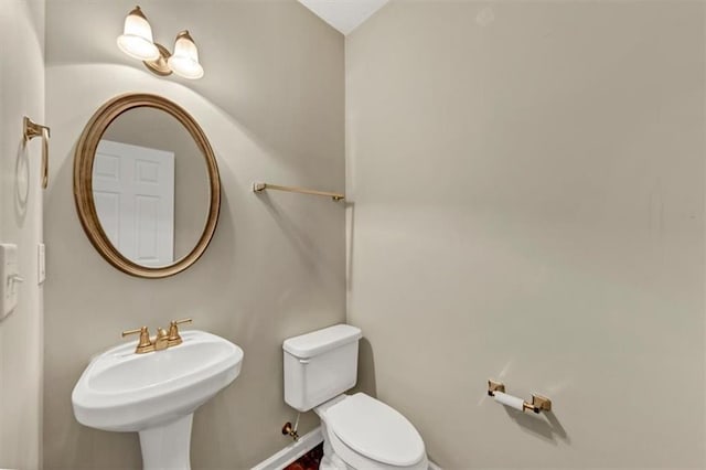 bathroom featuring sink and toilet