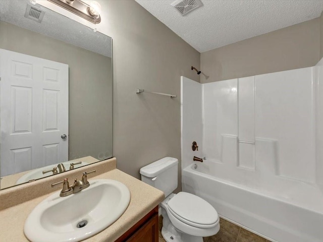 full bathroom featuring shower / washtub combination, tile patterned flooring, vanity, toilet, and a textured ceiling