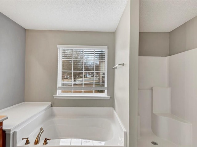 bathroom with vanity, a textured ceiling, and separate shower and tub