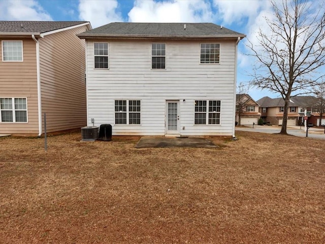 back of property featuring a patio, a yard, and central AC