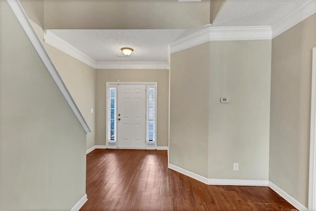 foyer featuring hardwood / wood-style flooring, ornamental molding, and a textured ceiling