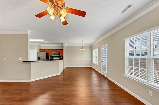 unfurnished living room with ornamental molding, dark hardwood / wood-style floors, and a textured ceiling