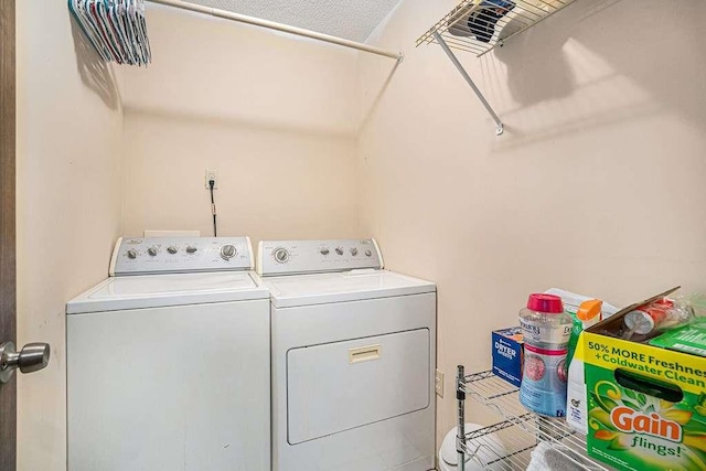 clothes washing area featuring washer and dryer