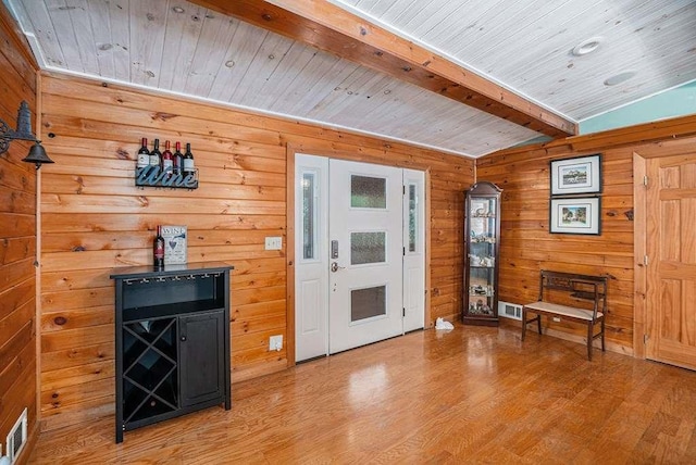 interior space with hardwood / wood-style flooring, vaulted ceiling with beams, and wood ceiling