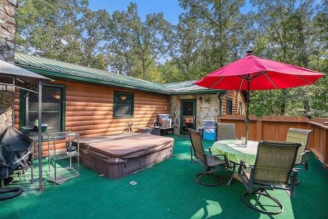 view of patio / terrace with a covered hot tub